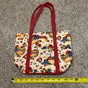 Longaberger tote with fruit basket pattern red handles.